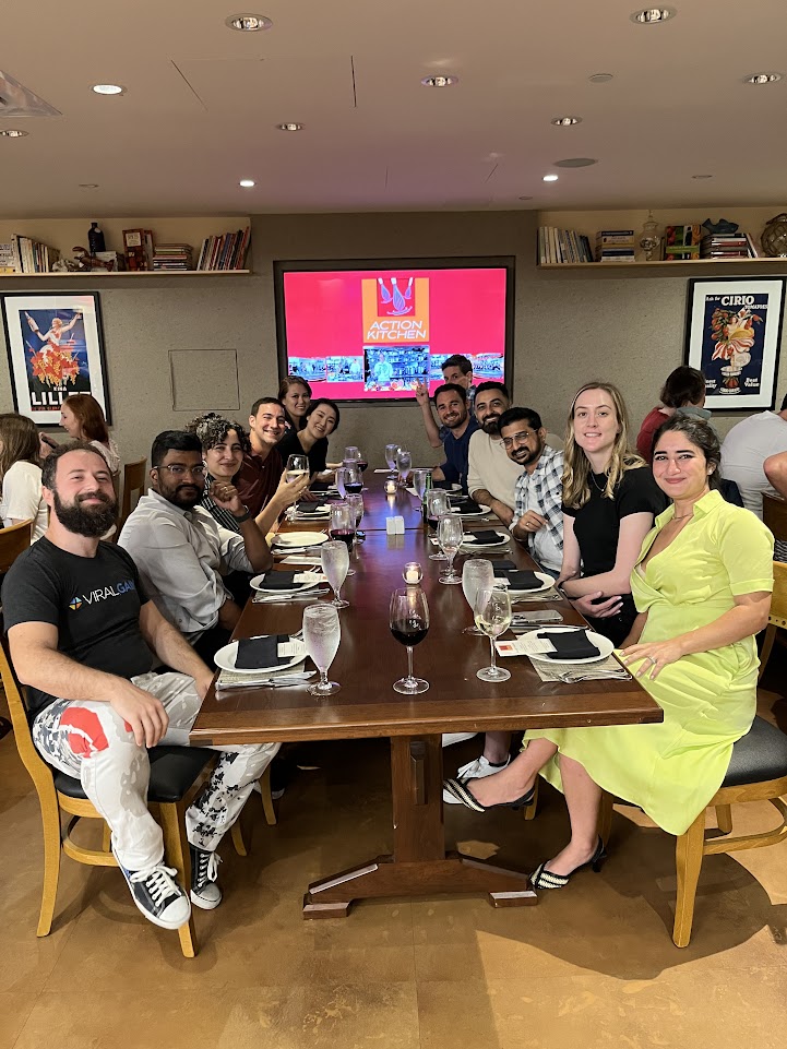 The ViralGains staff sitting at a large wooden table, prepared to eat