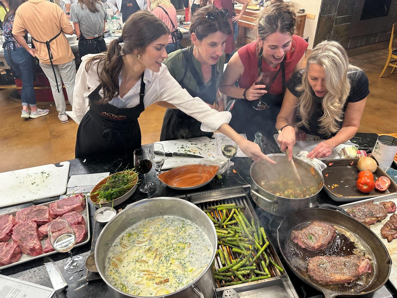 A chef instructing three people how to check if their soup is ready